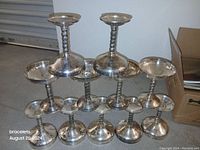 Set of ten champagne coupe glasses with twisted stems arranged in a pyramid stack.
