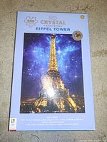 Boxed Crystal Edition Eiffel Tower puzzle with 500 pieces showing nighttime illuminated tower image.