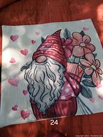 Decorative pillowcase with a gnome holding flowers and surrounded by hearts