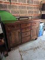 Front view of walnut buffet server credenza against brick wall