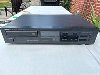 Front view of Yamaha CD-3 Compact Disc Player showing disc tray, control buttons, and display.