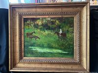 Full front view of framed painting with horses in a green landscape.