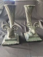 Front view showing both vases on black background