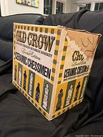Photo of the front side of the Old Crow ceramic chessmen box showing branding and limited edition label.