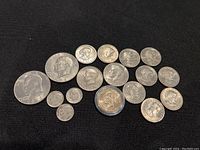 Top view of full coin bundle with all 17 coins shown, featuring various denominations and designs including large silver-colored coins and smaller nickels and dimes.