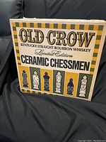 Outer cardboard box with Old Crow branding and Limited Edition Ceramic Chessmen text