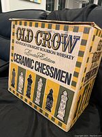 Box showing Old Crow Kentucky Straight Bourbon Whiskey Ceramic Chessmen Limited Edition branding with four chess piece images