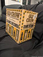 Box front showing Old Crow Kentucky Straight Bourbon Whiskey Limited Edition Ceramic Chessmen and 86 proof - six fifths information with illustrations of black and white chess pieces.