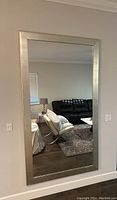 Full view of the Z Gallery rectangular mirror hanging on a wall in a living room.