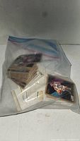Plastic bag containing a large stack of sports cards, mostly basketball, visible through the bag.