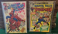 Photo showing two Spider-Man comics from Marvel, 'The Amazing Spider-Man: Chaos in Calgary' and 'Marvel Tales Starring Spider-Man', both bagged and carded.