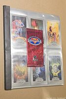 Binder cover page with six Superman Platinum Series cards visible plus unopened booster pack inserted in sleeve