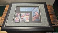Framed display of six different mint Elvis Presley stamps with accompanying descriptive plaque inside dark wood shadowbox frame.