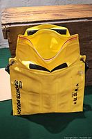 Yellow inflatable dry bag by SIMA in open view showing interior and closure flap.