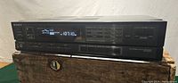 Front view of the SONY AM-FM Stereo Receiver STR-AV450 showing digital display tuned to FM frequency 107.1, buttons and controls on the front panel.