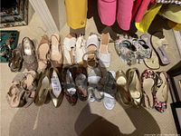 Overview of all 12 pairs arranged on carpet under clothing rack