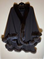 Front view of black wool cape with mink fur trim