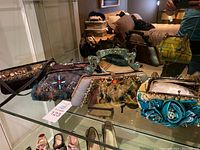 Four purses displayed on glass shelf