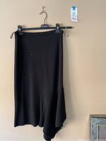 Black knit skirt with asymmetrical hem detail