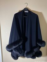 Front view of black wrap with fox fur trim