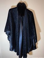 Front of black curly fur cape with mink collar