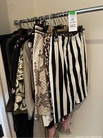 Rack of multiple skirts and tops on hangers showing variety of prints and styles