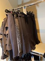 Rack of black skirts and tops hung on hangers