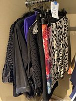 Rack view showing multiple skirts and tops on hangers