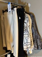 Rack view of multiple skirts and tops hung together