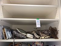 Shelf with 8 assorted purses and clutches arranged side by side