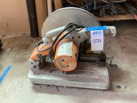 Side angle view of the cut off saw showing the base, handle, and general shape of the tool.