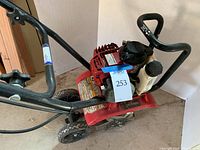 Full view of Honda gas powered rototiller showing handlebar, engine, and wheels.