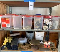 Shelf showing 20 plastic containers with screws, nails, chain links, 3 containers of wall plates, electrical cords and parts. Rolled cords and miscellaneous wire below with gloves and measuring tapes.