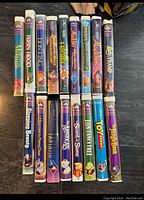 Front spines of 16 Disney VHS tapes showing titles and artwork.
