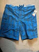 Blue plaid Speedo swim trunks XL with cargo pocket and drawstring closure, new with tags attached.