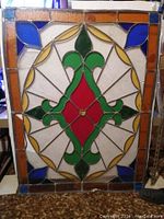 Full view of the large rectangular stained glass panel with colorful glass pieces in geometric and floral pattern.