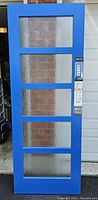 Full view of the cobalt blue door front showing five glass panels