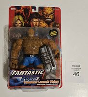 Front view of the sealed Thunder Launch Thing figure in original Marvel Fantastic Four packaging, showing figure and engine accessory.