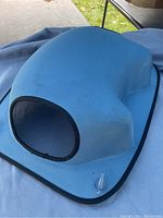 Blue dome-shaped cat tent with round mesh entrance visible from front