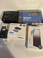 Lot items arranged on flat surface showing all items in packaging