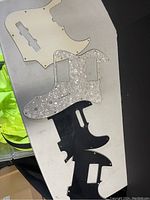 Four Fender guitar pickguards of different styles and colors laid out on a white surface.