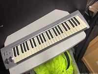 Full view of M-Audio KeyStudio MIDI keyboard controller with 49 keys on a table.