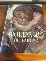 Front cover of Michelangelo The Painter book showing artwork and title.