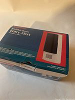 Photo of the boxed Radio Shack Invisible Beam Entry Alert device, showing packaging with product image and details.