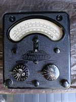 Close-up top view of Universal Avometer Model 40 analog needle and dual rotary dials showing measurement scales and brand markings.