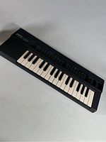 Yamaha PortaSound PSS-130 digital keyboard, showing full length and keys from an angle.