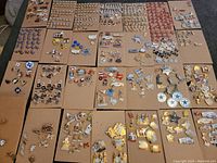 Multiple brown boards with hundreds of assorted trading pins including Texas shapes, badges, characters, and vehicles.