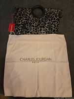 Charles Jourdan leopard print purse with dust bag displayed beneath to show branding and condition with tag attached.