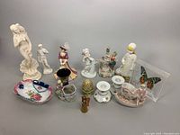 Full view of all porcelain figurines, candleholders, dishes, and decorative items including the Venus statue and butterfly block