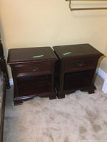 Pair of nightstands side by side on carpet against wall